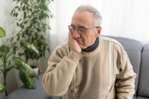 Older man suffering from jaw pain
