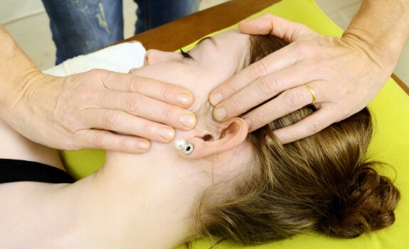 man grabbing nose and grimacing